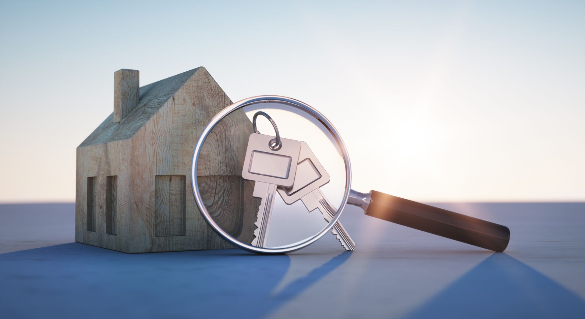 Holzhausmodell und Schlüssel unter einer Lupe. Symbol für Immobiliensuche mit SCHULER INVESTMENTS. Finden Sie Ihr Traumhaus.
